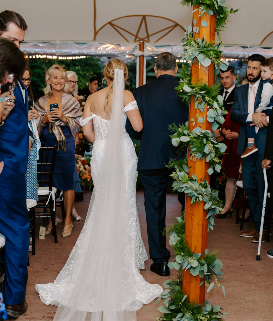 Bride and her father walk down the aisle during her rainy wedding day at The Willowdale Estate in Topsfield, MA.