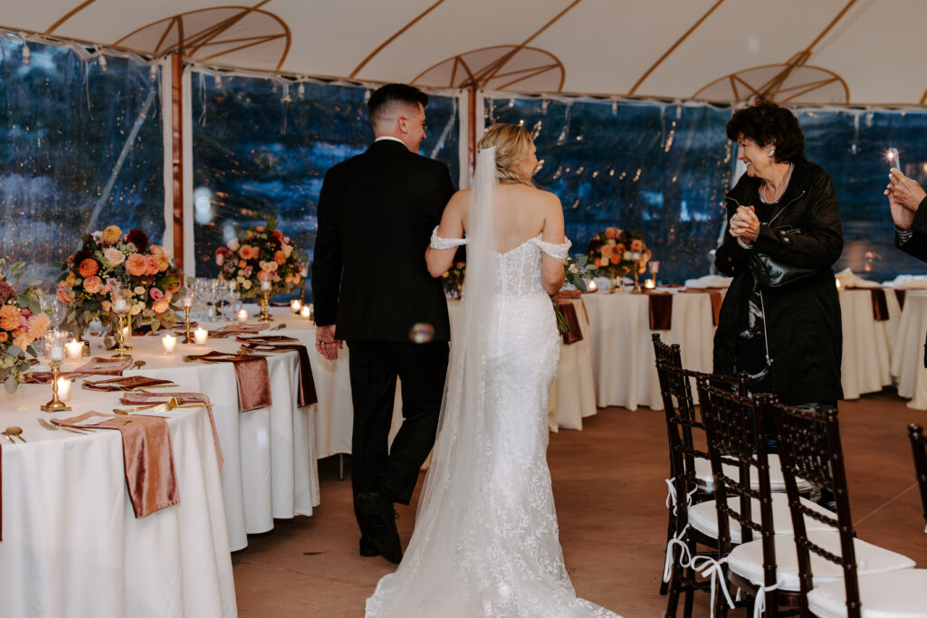 Bride and groom exit their wedding ceremony while bubbles surround them at The Willowdale Estate in Topsfield, Massachusetts.