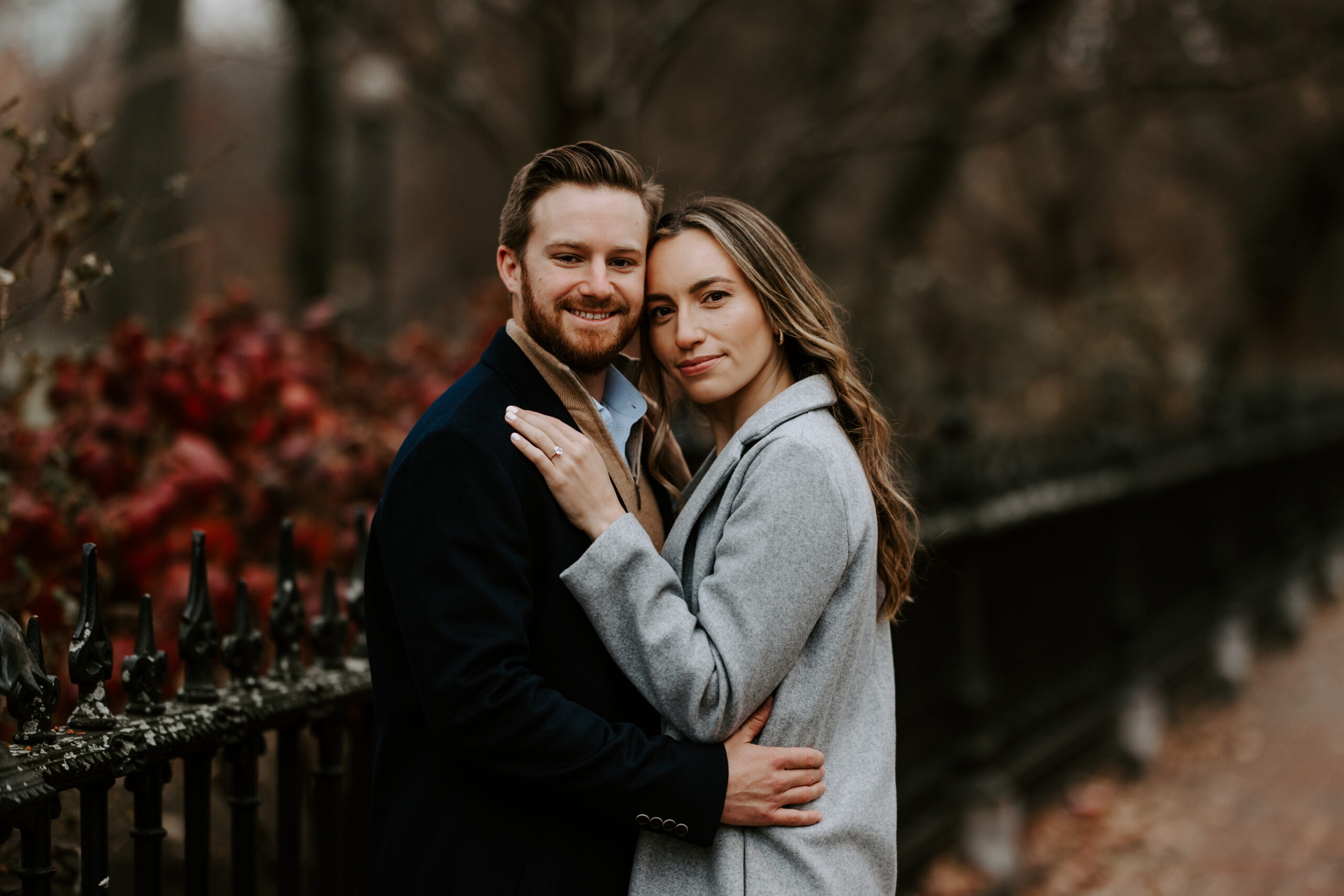 Man and woman smile towards camera in Boston after getting engaged!