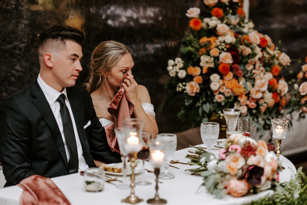 Bride wipes away a tear during toasts at their wedding reception at The Willowdale Estate.