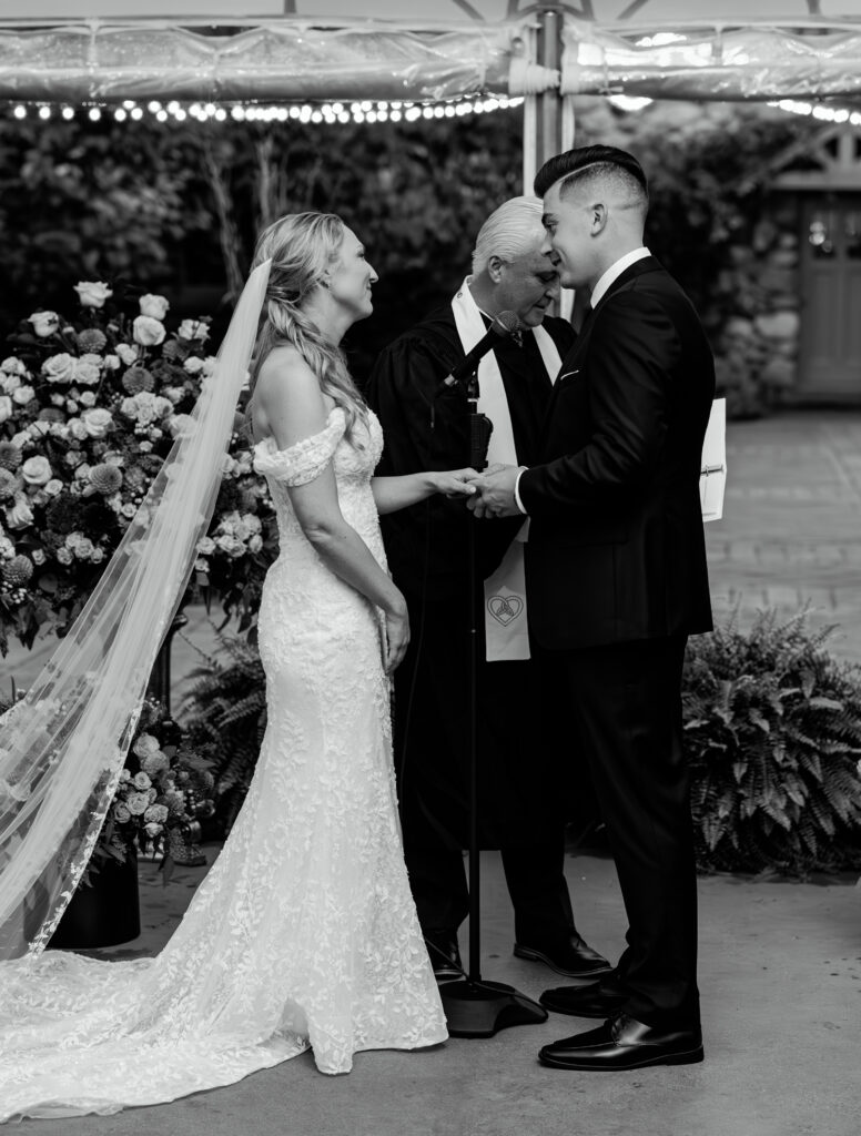 Bride and groom exchange vows and say their I dos during their wedding ceremony at The Willowdale Estate in Topsfield, MA.
