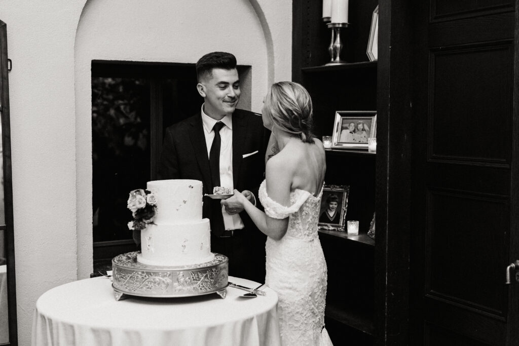 Bride and groom cut their wedding cake inside at The Willowdale Estate.
