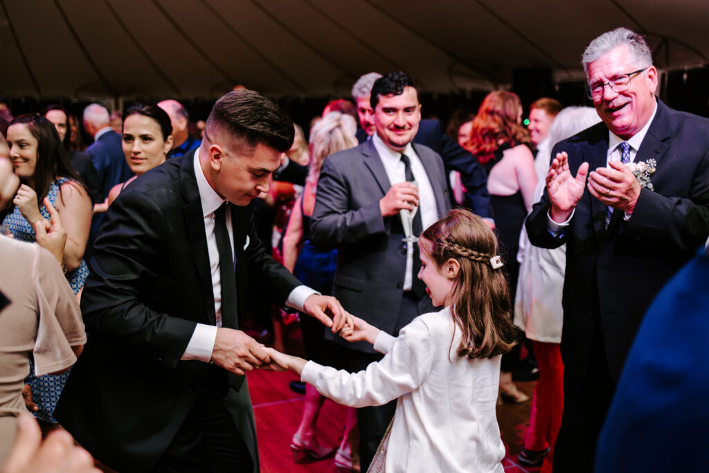 Groom dances with his niece during wedding reception at The Willowdale Estate.