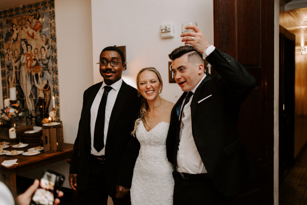 Bride and groom smile with a wedding guest at The Willowdale Estate.
