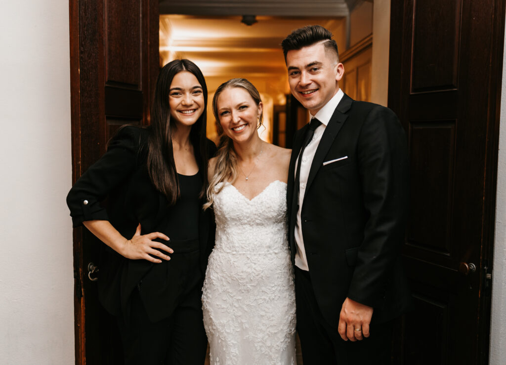 Bride and groom pose for a photo with their photographer, Gabrielle Shoots Photography, at their wedding at The Willowdale Estate.