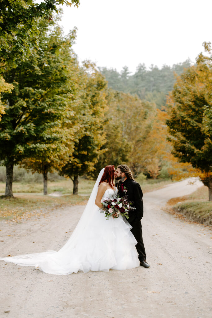 Bride and groom kiss at The Preserve at Chocorua