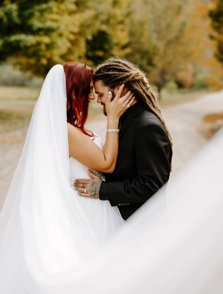 Bride and groom touch foreheads at The Preserve at Chocorua in Tamworth, New Hampshire