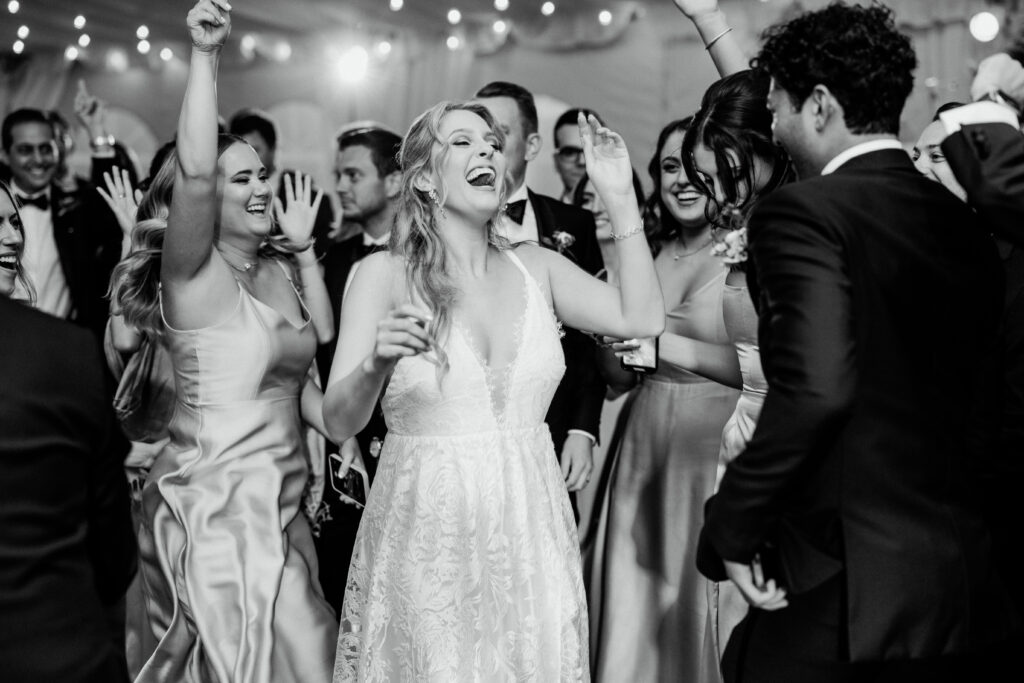 Bride laughs while dancing at wedding reception at Boston Wedding Venue