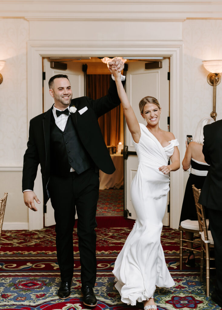 Bride and groom enter reception at The Wentworth By The Sea Golf Club in New Hampshire wedding