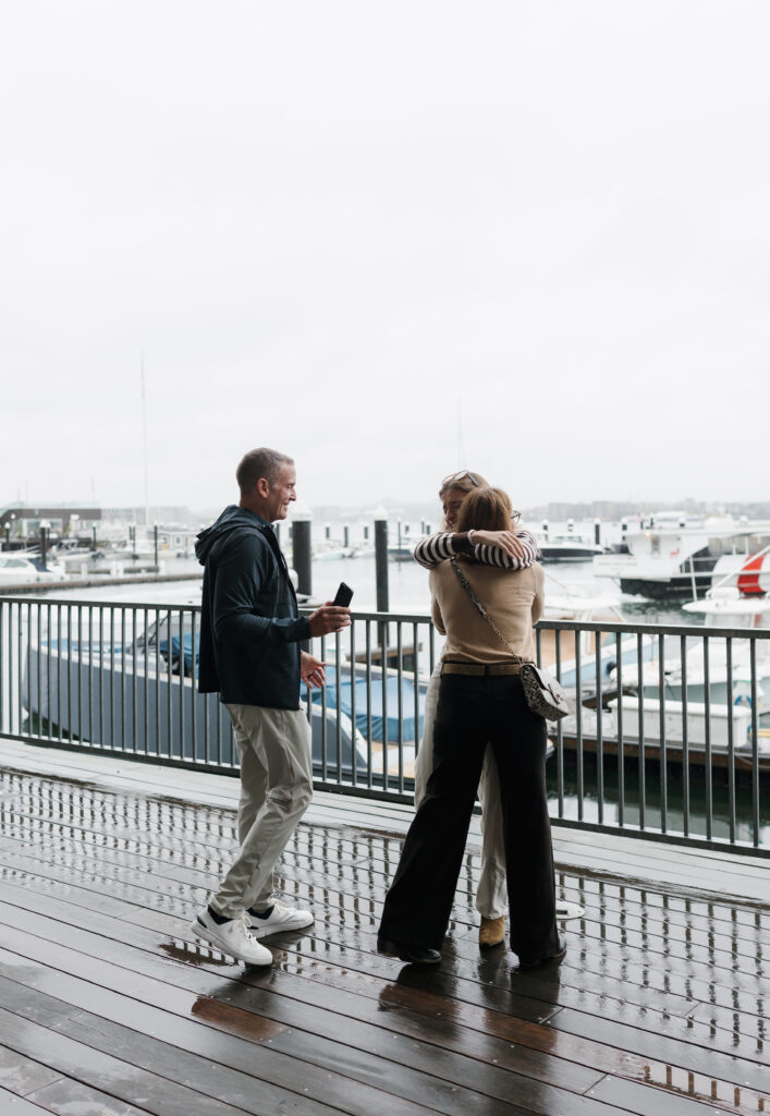 friends hugging after surprise proposal