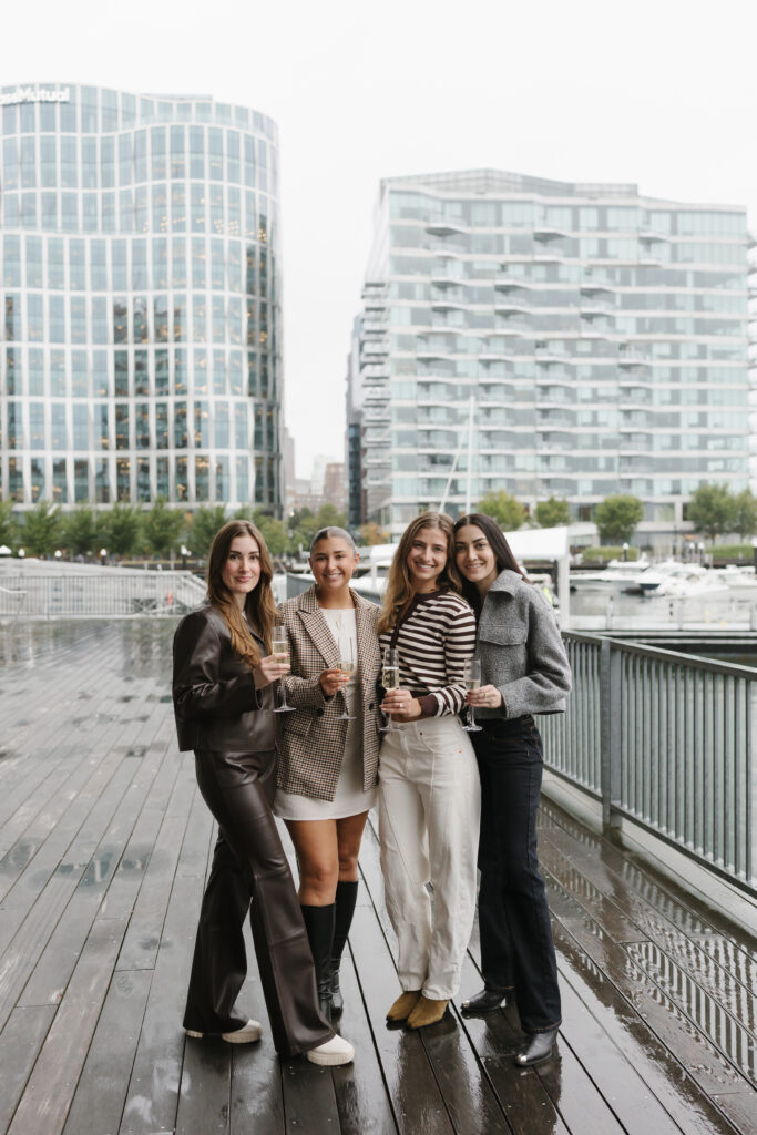 Friends after proposal engagement in Boston Seaport