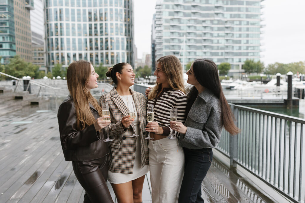 Friends after proposal engagement in Boston Seaport