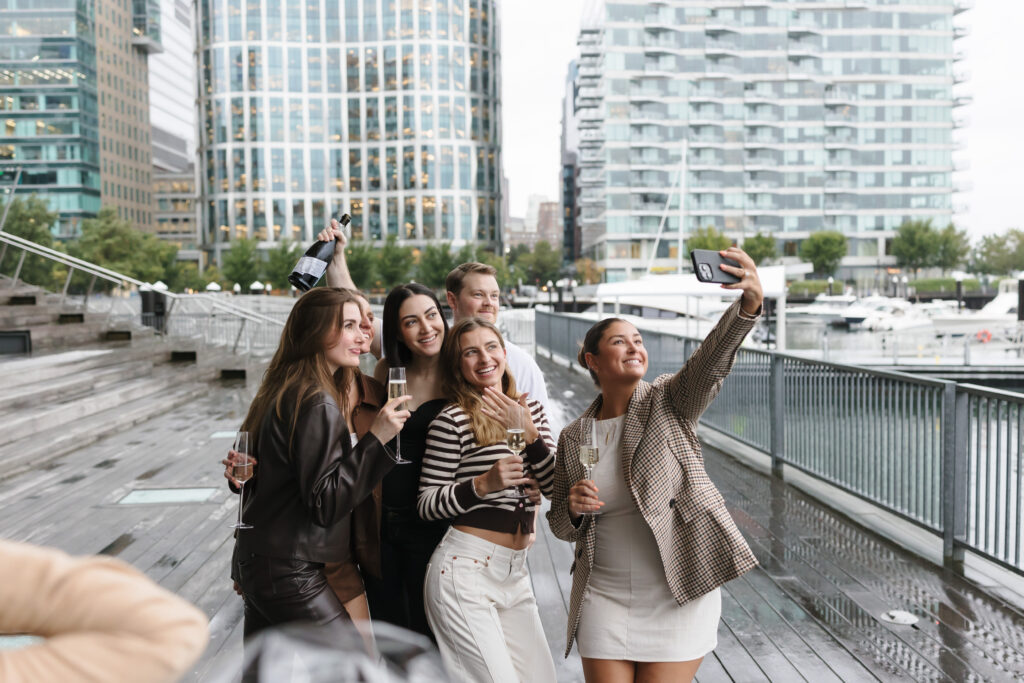 Friends after proposal engagement in Boston Seaport