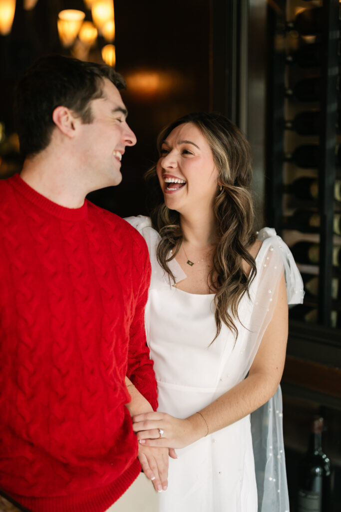 Bride laughs at groom during Boston engagement photos