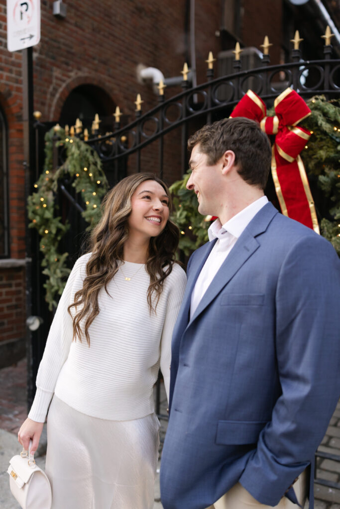 Bride looks at groom during cute massachusetts engagement photos