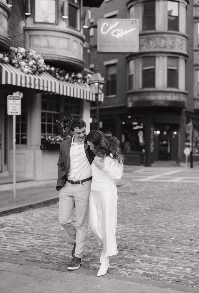Bride and groom walk playfully down the street in North End Boston
