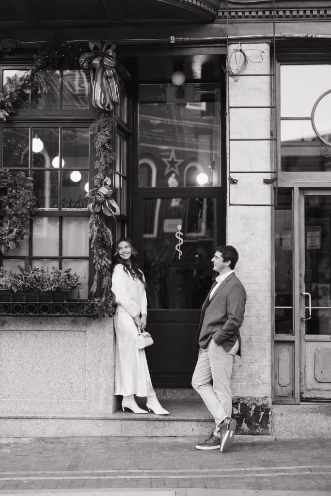 Bride looks away from groom at store front in Boston North End