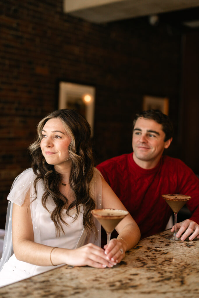 Groom looks at bride at the bar in Boston