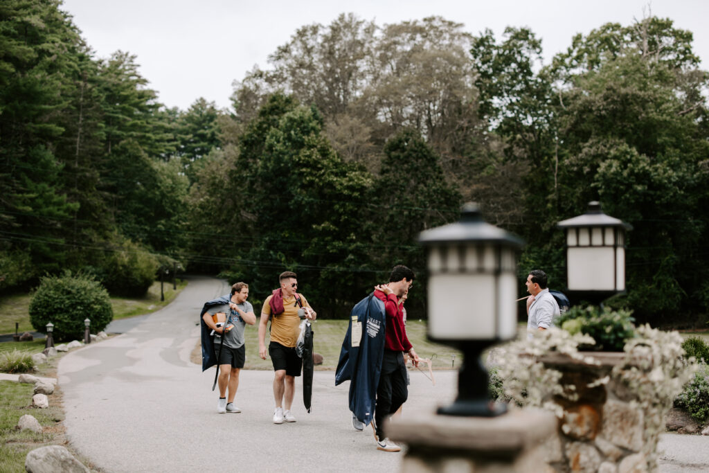 Groom and his groomsmen walk into The Willowdale Estate for his wedding.
