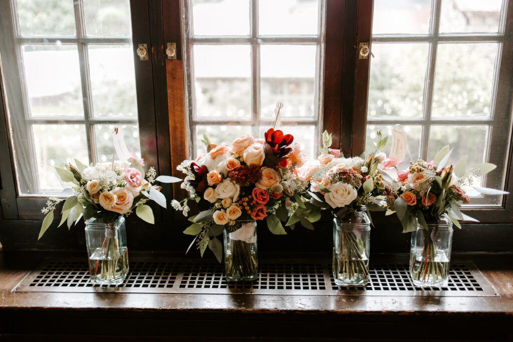 Bridesmaids and bride's bouquets along the window in the bridal suite at The Willowdale Estate for a fall wedding.