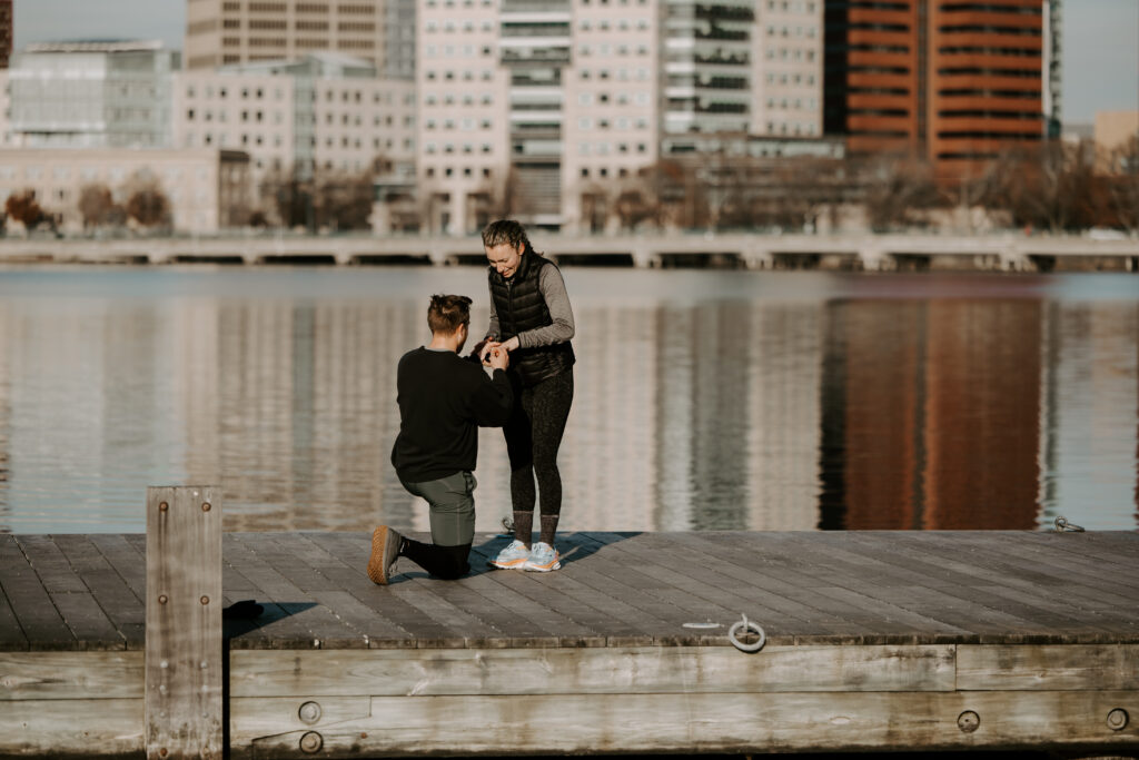 Woman is shocked after man proposes with her dream ring on The Charles River Esplanade in Boston, Massachusetts - he planned the perfect Boston proposal!
