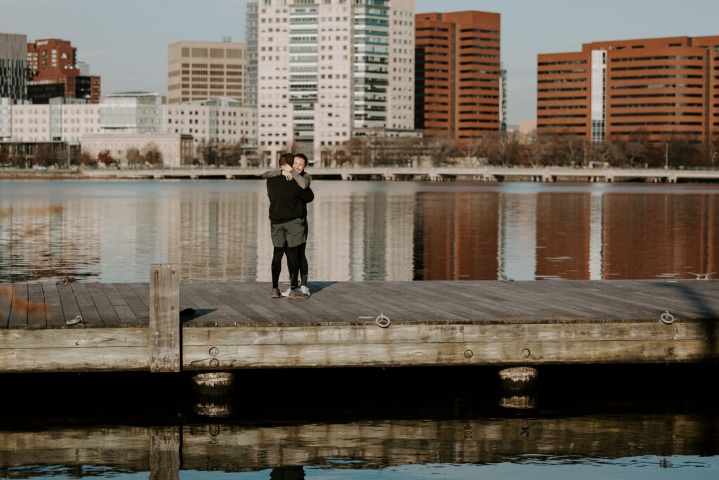 After getting proposed to with the perfect boston proposal, future bride tightly embraces her future groom with excitement in Boston, Massachusetts. He planned the perfect Boston proposal!
