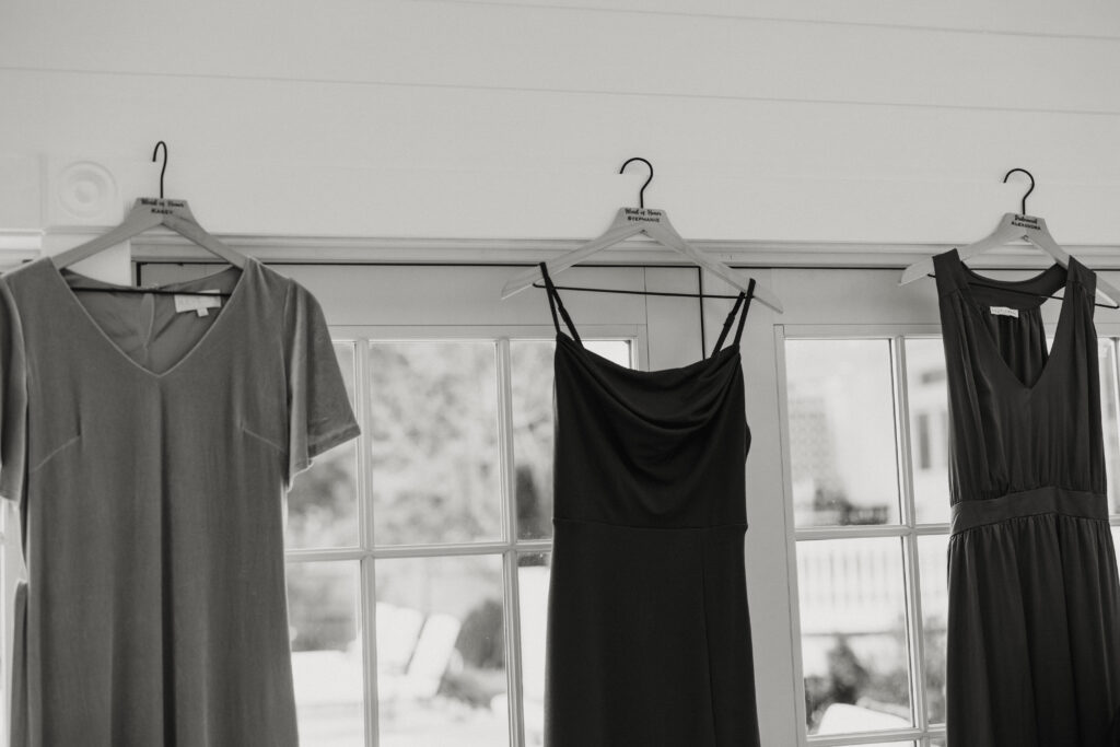 3 Bridesmaids dresses hung in getting ready room for fall wedding in Boston.