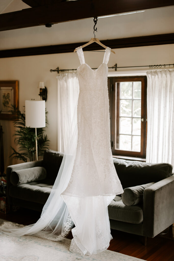 Wedding dress hangs in bridal suite at The Willowdale Estate for a fall wedding.