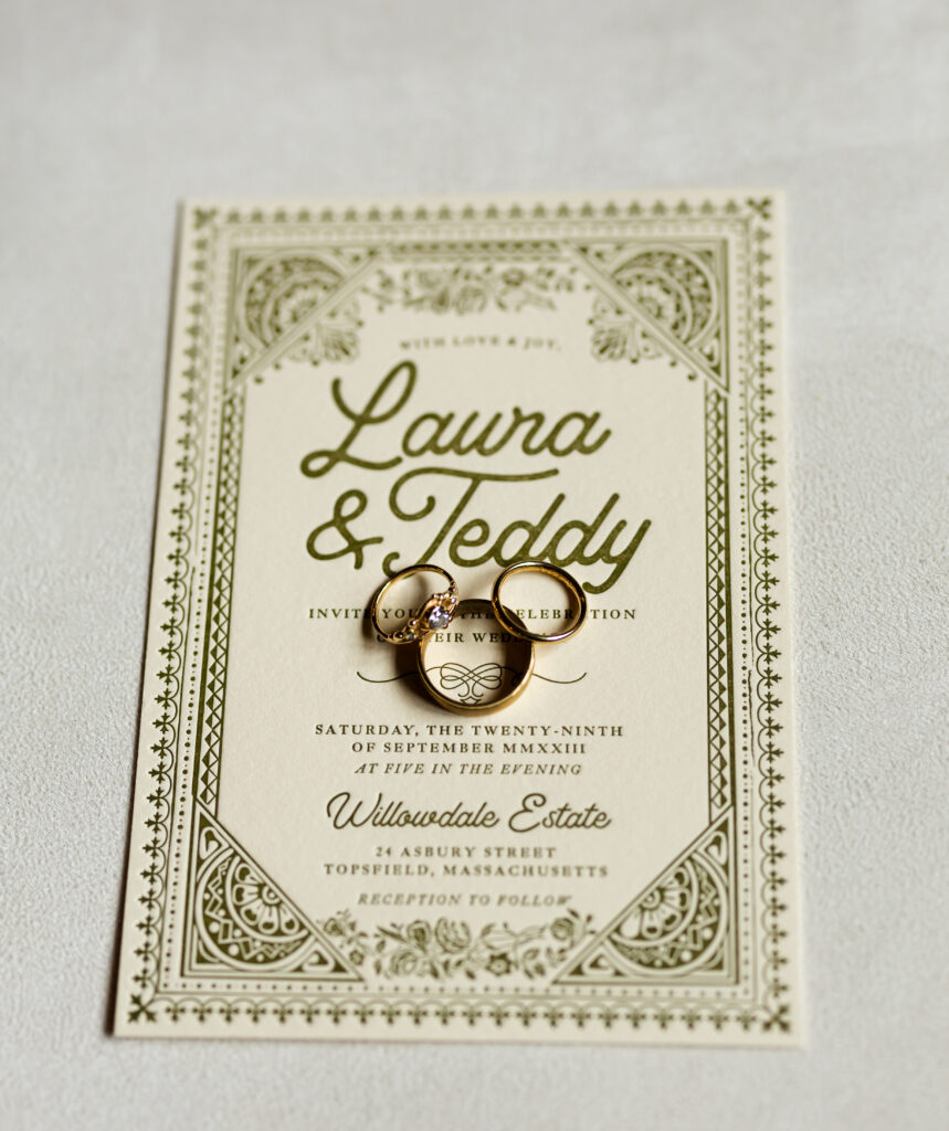 Wedding invitation for The Willowdale Estate with wedding bands and engagement ring.