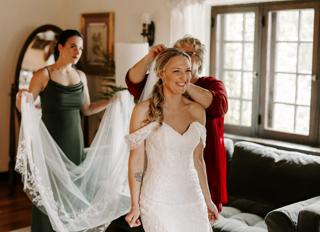 Maid of honor and bride's mother put bride's veil in for her wedding at The Willowdale Estate.