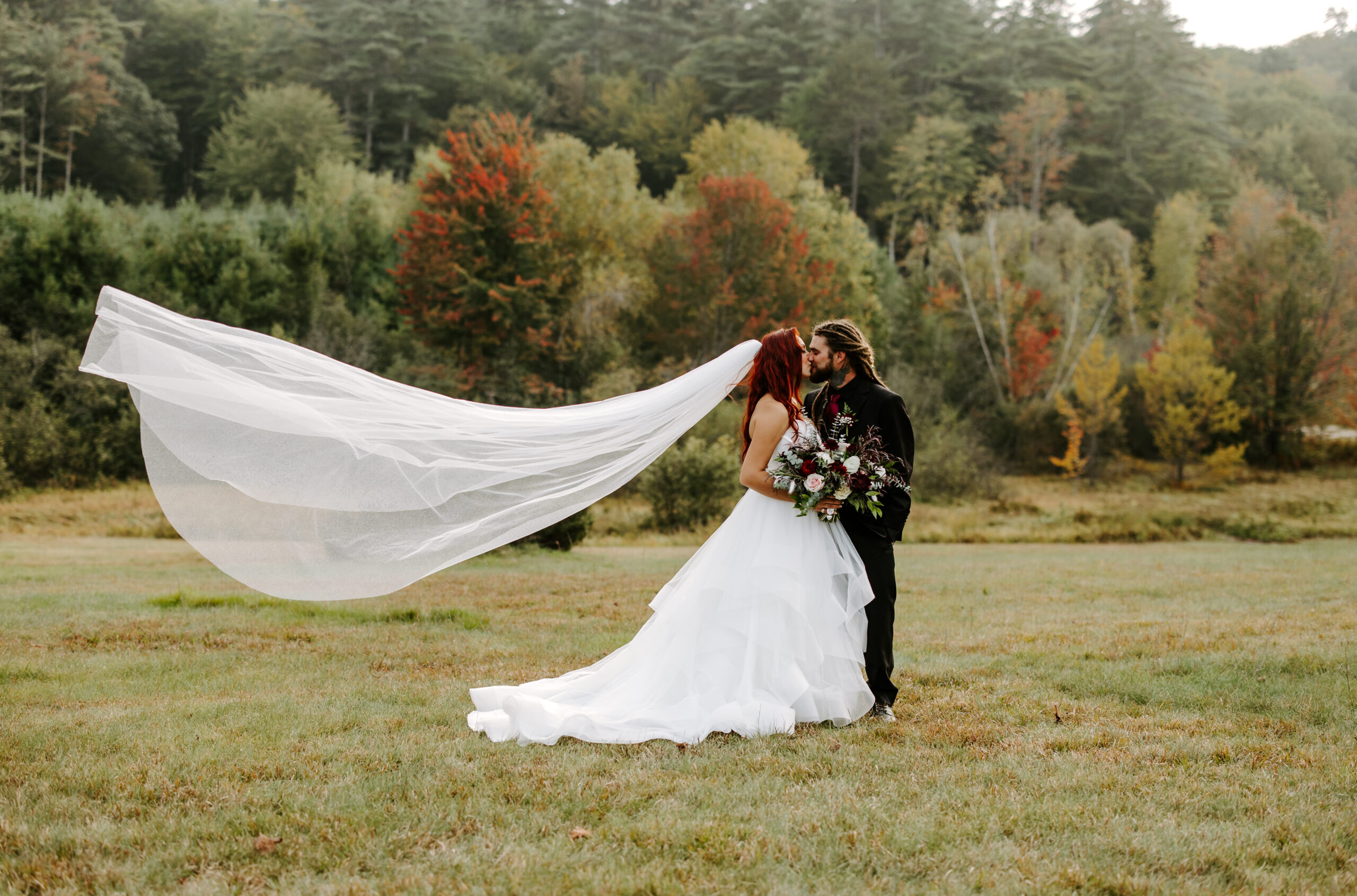 Bride and groom kiss at fall wedding at the preserve at chocorua