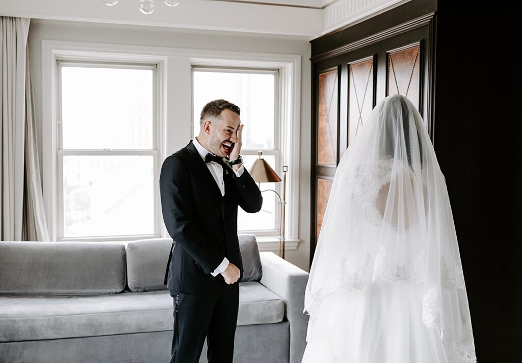 Bride and groom cry when seeing each other during first look on their wedding day at The Lennox Hotel