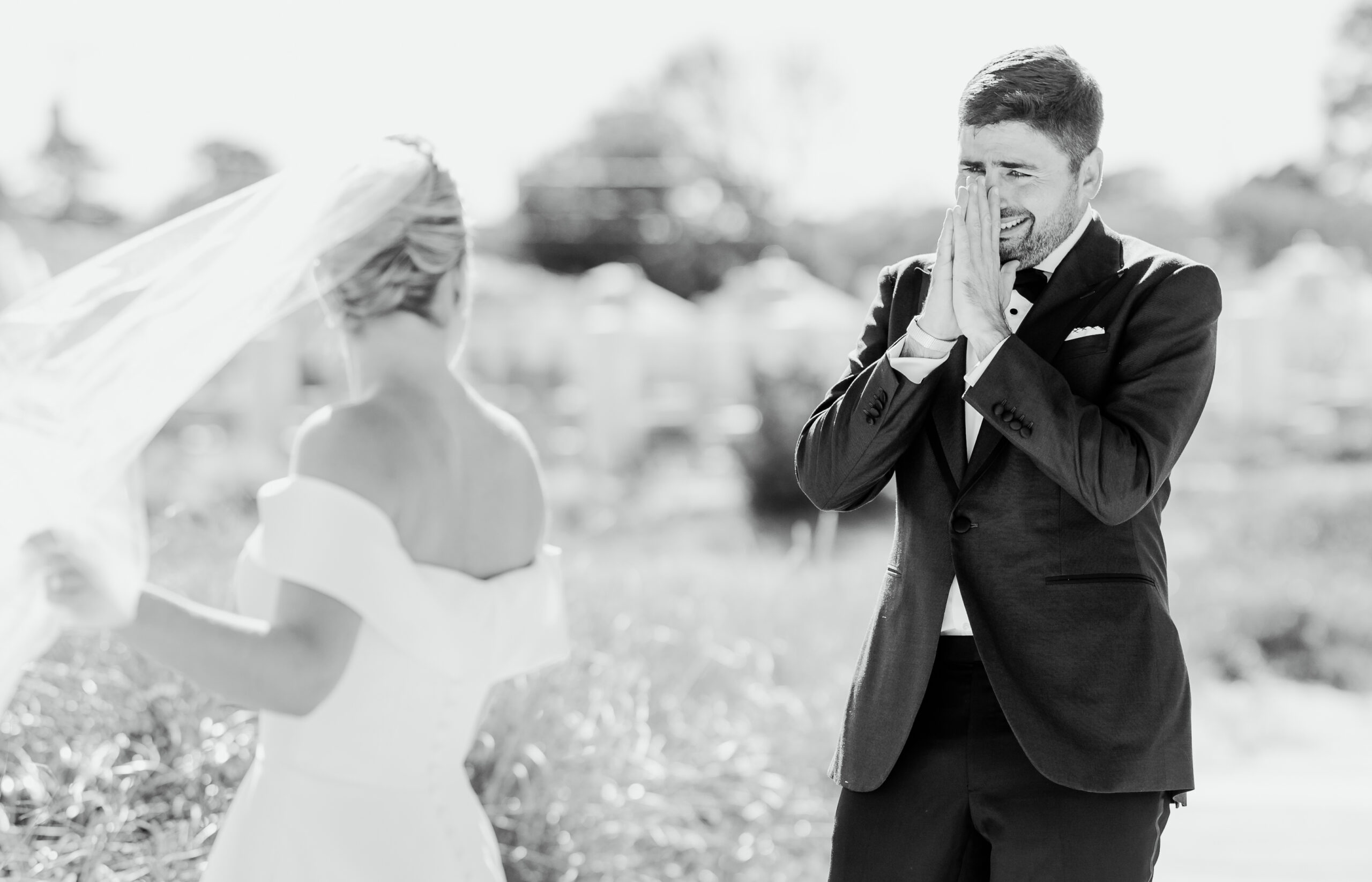 Groom wipes tears when he sees bride for the first time during first look on the beach