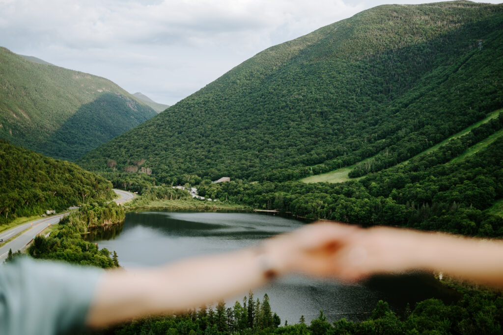 Echo Lake Beach and couples hands during summer mountain engagement photos in New Hampshire
