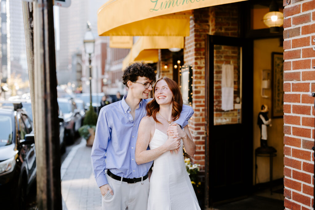 Groom and bride laugh at each other during engagement session