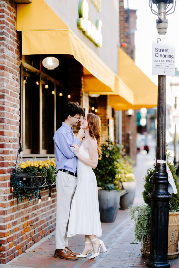 Groom holds brides chin and smiles in boston