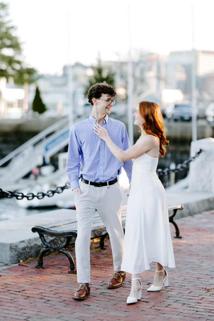 couple walks by the water during boston engagement photos