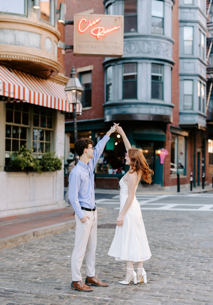 Groom spins bride in Boston north end engagement photo