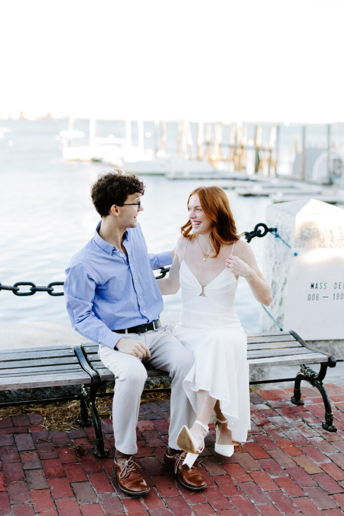 bride and groom laugh at each other in seaport boston