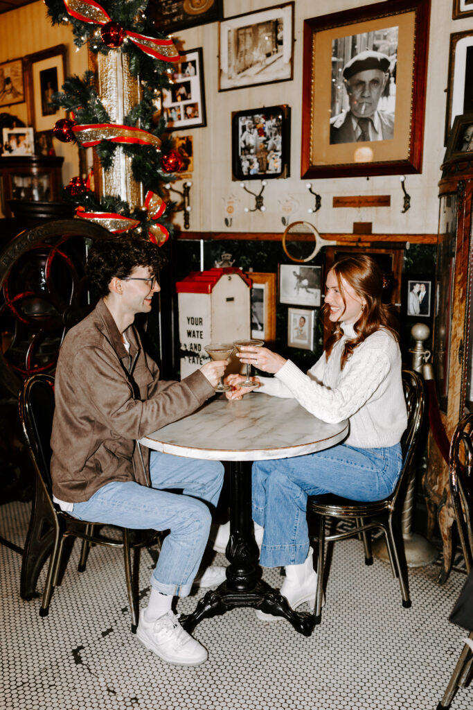 Couple cheers espresso martinis in a Boston cafe