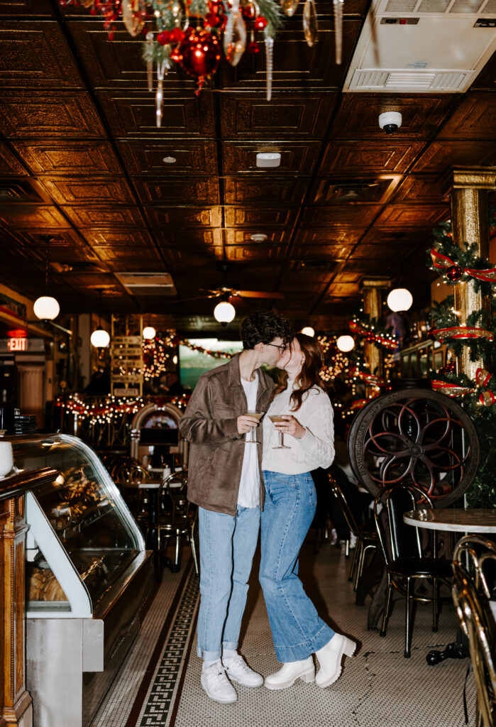 Bride and groom kiss in a cafe during boston engagement photos session