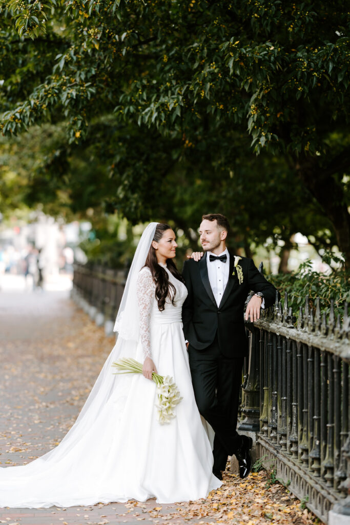 Couple looks at each other on Beacon Street on their fall wedding day at The Tower in Boston, Massachusetts.