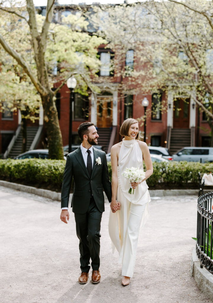 Boston wedding photographer. Couple walks hand in hand in Beacon Hill on their wedding day in Boston, Massachusetts